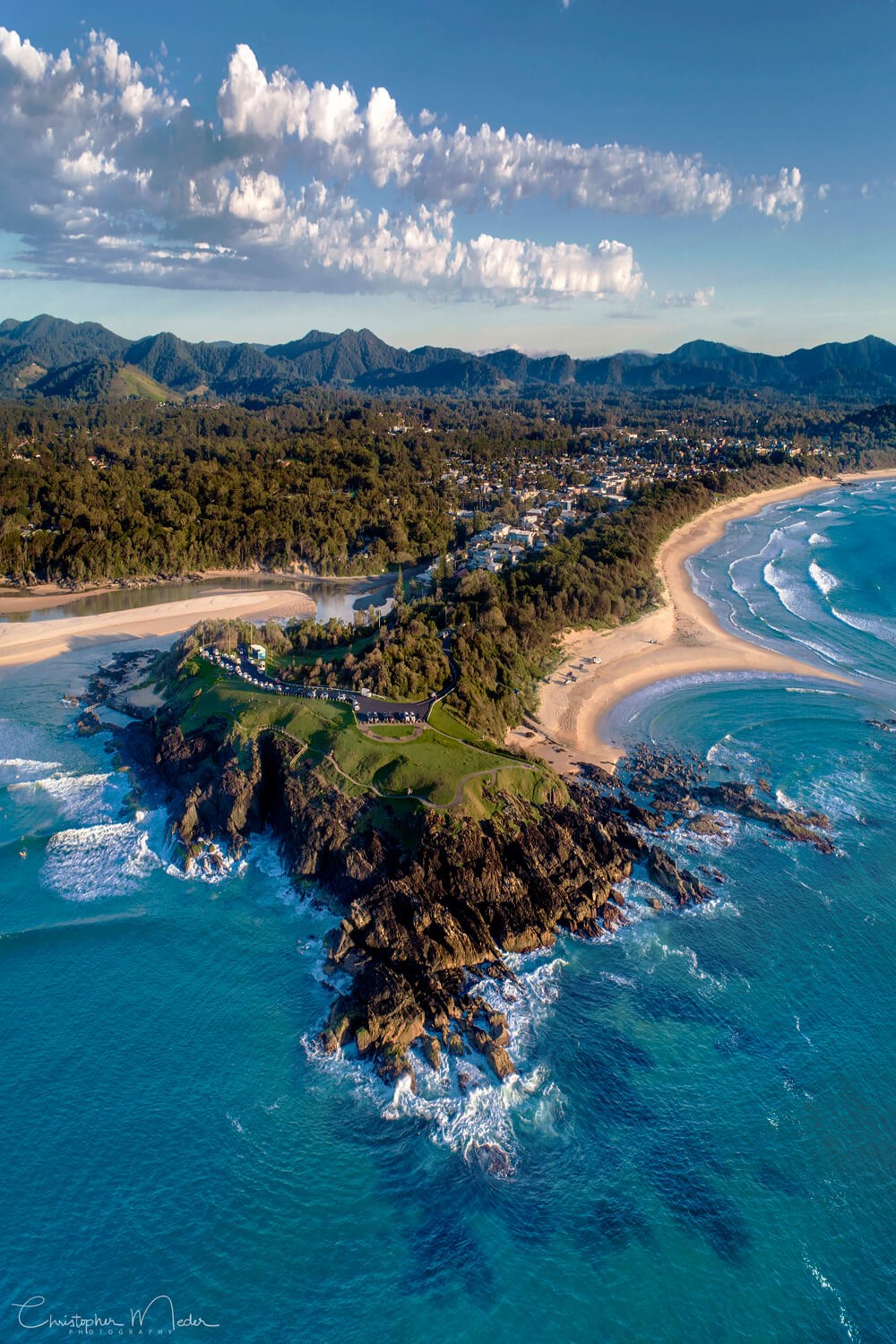 Aerial view of Sawtell headland, Bonville Creek and the surf beach at golden hour